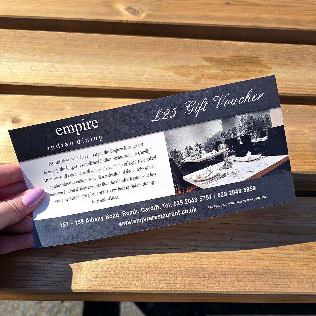 Uncoated Empire Indian Dining &pound;25 gift voucher with black and white restaurant photography, Cardiff contact details and classic black gift voucher design.