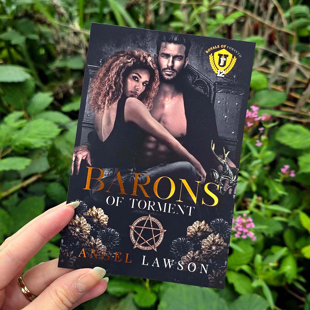 Copper foil Barons of Torment book postcard with dark photographic fantasy romance cover artwork, floral details and bold title typography.