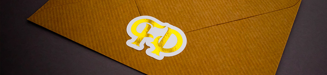The Foil Printing Co. logo as a gold foil sticker, sealing a brown envelope